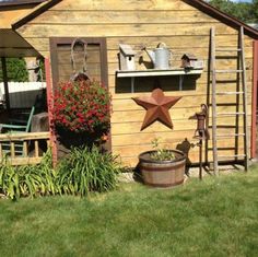 a garden shed with a potted plant next to it and a star on the wall