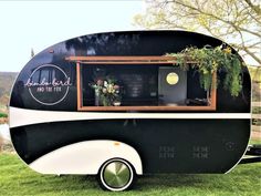 an old camper converted into a mobile home with plants growing out of the windows