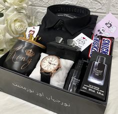 an open box containing men's personal care items, including a watch and perfume