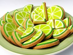 a plate full of cookies decorated with lime slices