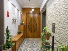 an entryway with potted plants and wooden doors