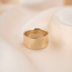 Please welcome our thickest band to date. Crafted in 14k Gold with a high polish, this statement ring might as well hold superhero powers within it. It's a piece that you'll cherish and pass down for generations. 14k Solid Gold 10mm Width Average weight: 12 grams Extra comfortable, with an inlay of gold circulating the inside of the band Since this ring is made to order, please allow 1 - 2 weeks for processing. Timeless Thick Band Ring As Gift, Timeless Thick Band Wide Ring As Gift, Timeless Wide Band Ring As Gift, Timeless Wide Band Ring 14k Gold, Modern Yellow Gold Wide Band Ring, Timeless Yellow Gold Wide Band Ring, Modern Wide Band Ring For Anniversary, 14k Gold Wide Band Ring With Polished Finish, Timeless Thick Band Ring For Anniversary