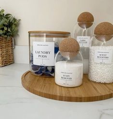 three jars with labels on them sitting on a counter