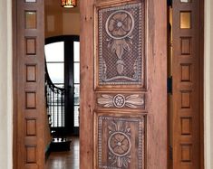 an open wooden door with decorative designs on the front and side panels inlays