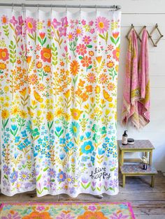 the shower curtain is decorated with colorful flowers