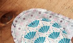 two plates sitting on top of a wooden table covered in blue and white designs with polka dots