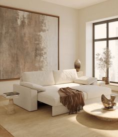 a living room with a large painting on the wall next to a white couch and coffee table