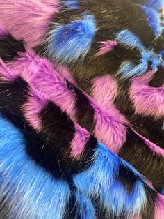 several different colored furs are stacked together