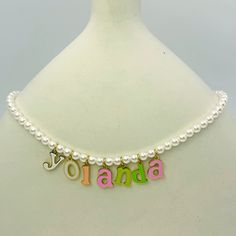 Embrace elegance with a touch of fun with our Charmed Pearl Letter Necklace. This exquisite piece features a string of lustrous pearls, accentuated by colorful enamel-coated letters that spell out your chosen name or meaningful word. Perfect for adding a personalized charm to any outfit, this necklace is both sophisticated and playful, making it a standout accessory in your jewelry collection.