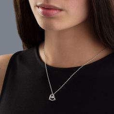 Cute and quirky, this diamond accented tilted heart is a thoughtful look they'll love. Crafted in sleek sterling silver. The swirling open heart-shaped frame is centered with a sparkling diamond accent in a unique movable frame. The pendant suspends along an 18.0-inch rope chain that secures with a spring-ring clasp. Silver Heart Detail Jewelry For Mother's Day, Elegant Open Heart Jewelry With Heart Detail, Silver Heart Cut Jewelry With Heart Detail, Diamond Open Heart Charm Jewelry, Sterling Silver Double Heart Jewelry With Heart Detail, Double Heart Sterling Silver Jewelry With Heart Detail, Sterling Silver Open Heart Jewelry With Diamond Accents, Fine Jewelry Open Heart With Diamond Accents, Silver Open Heart Jewelry With Diamond Accents