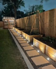 an outdoor garden area with lights on the side and steps leading up to the back yard