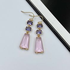 Drench your ears in a pastel dream with these dangle earrings, adorned with soft pink and gentle purple crystals. The delicate hues of pink meld beautifully with the subtle purple, evoking memories of twilight skies or spring blossoms. Perfect for those who cherish a touch of feminine elegance and whimsy, these earrings offer both grace and charm in equal measure. Measurements: The total length from the top of the hook to bottom - 1.96 inches (50 mm) approximately. Connector crystals: 6 mm x 5 mm Drop crystal: 20 mm x 10 mm These earrings would be a PERFECT GIFT for you and your family and friends! Our jewelry comes beautifully packaged in a gift box!   Click here to see more Modern Everyday Earrings: https://etsy.me/2UJldl1 Thank you for your visit! Lavender and Soft Pink Crystal Earrings Pink And Purple Earrings, Elegant Lavender Earrings For Party, Lavender Drop Earrings For Party, Elegant Lavender Drop Earrings, Purple Bridal Earrings With Matching Set, Lavender Dangle Earrings For Formal Occasion, Elegant Lavender Crystal Earrings For Party, Purple Dangle Bridal Earrings, Elegant Lavender Earrings With Ear Wire