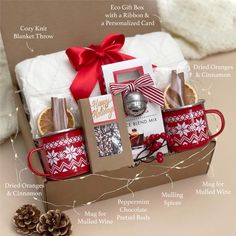 a christmas gift box with coffee mugs and other items