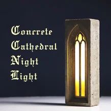 a candle that is sitting in front of a window with the words concrete cathedral night light on it