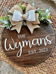 the wymans est 202 sign on a wicker basket with a bow and greenery