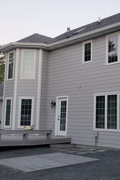 a large gray house with white trim and windows