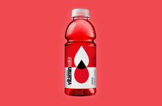 a bottle of water on a red background