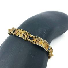 Vintage gold tone filigree bracelet, This lovely bracelet consists of eight beautiful rectangular filigree panels each with a repousse floral detail. It has a spring-ring clasp. Unlike anything made today! A great piece for gifting! CONDITION Good vintage condition. DIMENSIONS 7″ x 1/4″ Jewelry comes in a box ready for gift-giving Questions for me? Scroll down and click Message Tracey, I will get back to you typically within a few minutes. Ready to buy? Click Add to Cart and pay with Pay Pal or credit card. Satisfaction is guaranteed. Your vintage treasure will be carefully packaged and on it's way to you typically within 24 hours. Need something for your home? Visit www.vivaterravintage.etsy.com for a selection of vintage lovelies for the home. Ornate Yellow Gold Bracelets With Intricate Design, Ornate Yellow Gold Bracelet With Intricate Design, Antique Gold Rectangular Bracelet, Victorian Filigree Bracelets In Yellow Gold, Victorian Yellow Gold Bracelet With Filigree, Victorian Yellow Gold Filigree Bracelets, Gold Rectangular Filigree Jewelry, Ornate Gold Bracelets For Formal Occasions, Antique Etched Gold Bracelets