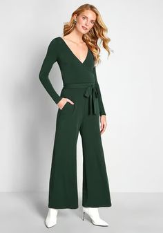 Highlight your propensity for polish with this dark green jumpsuit from our ModCloth namesake label! Crafted from a stretch-infused crepe fabric, and detailed with long sleeves on either side of the surplice neckline, a sleek waist sash, and essential pockets, this wide-leg one piece is a surefire stunner for casual outings and swanky occasions alike.
95% Polyester, 5% Spandex. 
Machine wash. 
Side pockets. Removable sash.
Made in the United States
Model is wearing size:
1X  S 
Fabric provides s Formal Jumpsuits And Rompers For Fall, Green Long Sleeve Jumpsuits And Rompers For Work, Green V-neck Jumpsuit For Formal Occasions, Green Long Sleeve Jumpsuit For Fall, Green V-neck Formal Jumpsuits And Rompers, Belted V-neck Jumpsuits And Rompers For Fall, Chic Green Jumpsuits And Rompers For Fall, Elegant Fall Jumpsuits And Rompers With Tie Waist, Tie Waist Long Sleeve Jumpsuits And Rompers