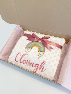 a cake in a box with a rainbow on it