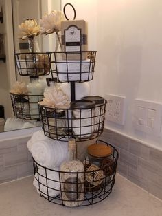 three tiered basket filled with items on top of a bathroom counter