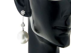 Classy dangle earrings, made of 18k solid white gold with 0.500ct sparkling genuine natural diamonds & 2 natural white, genuine south sea cultured pearls from Australia. Each of the Top grade Fine Drop shape, genuine south sea white pearl exhibits excellent high luster, thicker nacre with silky smooth and clean surface. Style: Dangle. Metal Purity: 18k Solid White Gold. Genuine Diamonds: 28 pcs / 0.500ctw. Earring Weight: Pearl Type: Genuine South Sea Cultured Pearl. Pearl Origin: Broome; We White Platinum Dangle Diamond Earrings, Elegant Platinum Diamond Earrings, Elegant White Platinum Earrings, Elegant White Platinum Bridal Earrings, White Drop Diamond Earrings With Brilliant Cut, White Brilliant Cut Dangle Diamond Earrings, White Diamond Earrings With Prong Setting For Evening, White Brilliant Cut Drop Bridal Earrings, Elegant White Gold Drop Diamond Earrings