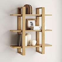 a wooden shelf with books and vases on it