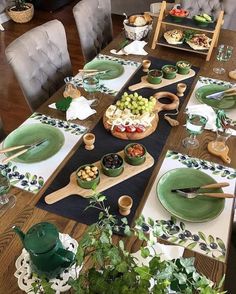 the table is set with green dishes and plates