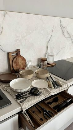 the kitchen counter is cluttered with dishes and utensils