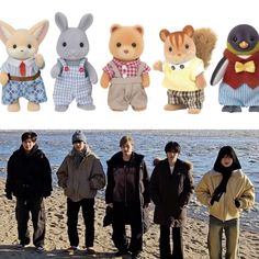 several people standing on the beach with stuffed animals in front of them and one person wearing an animal costume