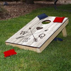 a cornhole game set up in the grass with red and blue pieces on it