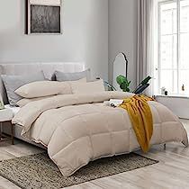 a bed with white comforter and pillows in a room