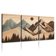 three pieces of wood with mountains and trees on them