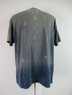 "Vintage 1980s blue cotton sports t shirt with white and yellow graphics. Eggleston's Softball Complex Champions. Has distressed paint all over and very sun faded. Size XL. Actual measurements are: 47\" around the chest 47\" at the waist 21.5\" shoulder seam to shoulder seam 29\" overall length" Pre-washed Relaxed Fit T-shirt For Streetwear, Vintage Pre-washed Cotton T-shirt, Pre-washed Short Sleeve Grunge T-shirt, Pre-washed Short Sleeve Tops For Summer, Vintage Faded T-shirt Pre-washed, Vintage Faded T-shirt With Screen Print, Pre-washed Crew Neck Graphic Tee, Vintage Acid Wash Pre-washed T-shirt, Pre-washed Cotton Graphic Tee