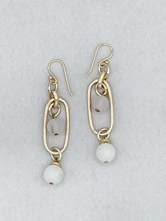 Featuring a beautiful white stone bead design, these Zephyr Chain Earrings offer classic elegance with a modern touch. Whether you are looking for a subtle addition to an evening look, or a casual piece to add to your day-to-day wardrobe, these earrings are a perfect choice. Crafted with quality sterling silver, these earrings are sure to be a timeless addition to your jewelry collection. Details: Dangle Earring Paperclip Chain Link Cloud White Stone Beads Handmade French Hook Ear Wire Approxima Elegant Round Beaded Metal Earrings, Elegant Metal Beaded Earrings With Round Beads, Elegant Everyday Jewelry With Dangling Beads, Elegant Metal Jewelry With Dangling Beads, Elegant Beaded Chain Dangle Earrings, Elegant Adjustable Beaded Earrings, Elegant Beaded Chandelier Earrings, White Metal Dangle Linear Earrings, Everyday White Jewelry With Dangling Beads