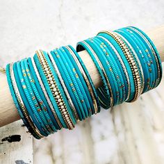 Beautifully designed bangles for any occasion. South asian bracelets come in a variety of styles, colors, and finishes. We at Banglez take creating the perfect bangle set for you to another level! You could say helping you find your favorite stack of bangles as one of our greatest missions. This bangle set was curated in house by one of our talented team members. We hope you love them as much as we do! Bohemian Stackable Bangle For Party, Stackable Bohemian Bangle For Party, Turquoise Bangle Bracelets For Wedding, Turquoise Bangle Bracelet For Weddings, Festive Stackable Beaded Bangle Bracelets, Festive Stackable Bracelets For Festivals, Turquoise Bangle Bracelet For Party, Turquoise Bangle Bracelets For Party, Stackable Festival Bangles