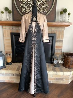 "This is a designer Renaissance dress with incredible black satin and champagne fabric. Lots of ornate trim.  Gemstones trim out jacket along with satin bows. Zips up back. Pewter necklace with cross gemstones finish this masterpiece. Chest 36-38\", waist 30-32\", length 58\". You will never see another like this." Champagne Fabric, Burgundy Formal Dress, Necklace With Cross, Armor Dress, Apron Dress, Yes To The Dress, Fantasy Dress, Historical Dresses, Fantasy Clothing