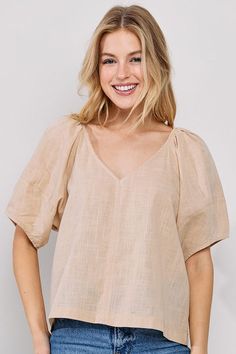 The Shelby Linen Top is the perfect choice for a sophisticated yet comfortable summer look. Crafted from a lightweight linen fabric, this V-Neck top features short sleeves and a waist-length cut, offering an airy feel to any wardrobe. With a timelessly chic silhouette, the Shelby Linen Top is an effortless way to make a statement.Perfect for high summer, style with smocked linen top to wear under and our wide leg linen pants. -Content: 100% Linen -Hand wash cold -Relaxed fit Model wears size S Wide Leg Linen Pants, Lightweight Tops, Summer Look, Linen Top, V Cuts, Waist Length, Linen Pants, V Neck Tops, Summer Looks