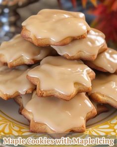 a plate full of iced cookies with icing on them and the words maple cookies with maple toppings