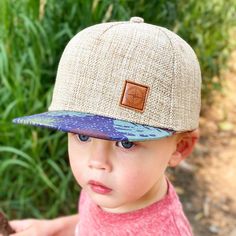 "For your adventure-loving little wanderer, our \"San Blas\" kid's and toddler hat is adorned with a small, brown compass patch on a light linen hat with a custom print floral fabric on it's flat brim. This one is super special and is the perfect back to school accessory. ~ Mid-profile kid's trucker cap ~ Brown compass patch, with linen cap and a floral print flat brim. ~ Adjustable snapback closure lets you personalize your fit ~ Cotton / Linen / Leather ~ Two sizes; Made for kids; Imported Tee Hats For Kids, Made For Kids, Baby Sun Hat, Printed Flats, San Blas, School Accessories, Toddler Hat, Jan 20, Cute Hats