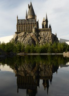 a castle is shown with its reflection in the water