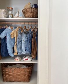 an organized closet with clothes and baskets