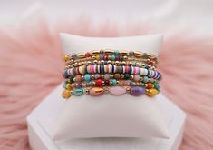 Enhance your accessory game with our Gold Mixed Up Multicolored Beads Bracelet Set. This set features a mix of gold and multicolored beads for a unique and stylish look. Perfect for any occasion, you'll love the versatility and eye-catching design of this set. Elevate your style with this must-have accessory. Size: 6.5” - Inner Diameter Closure: Elastic Material: Zinc, Brass and Steel with Rhodium Plating Lead and Cadmium Safe - It is not Nickel Free Cheap Multicolor Adjustable Stretch Bracelet, Multicolor Friendship Bracelets With Gold Beads As Gift, Trendy Gold Beaded Bracelets With Heishi Beads, Trendy Gold Friendship Bracelets With Colorful Beads, Bohemian Multicolor Friendship Bracelets With Gold Beads, Multicolor Gold Beads Stretch Bracelet Gift, Multicolor Stretch Bracelet With Gold Beads As Gift, Multicolor Heishi Beads Bracelet With Gold Beads, Trendy Gold Beaded Bracelets With Colorful Beads