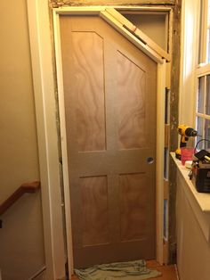 an unfinished door is being installed in the hallway