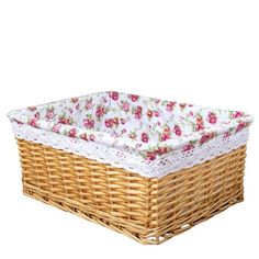 a wicker basket with pink flowers on the bottom and white lace trimmings