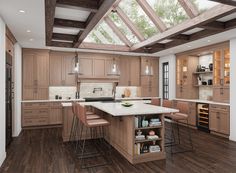 a large kitchen with an island in the center and wooden cabinets on both sides, along with two bar stools