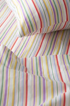 multicolored striped sheets are folded neatly