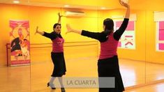 two women are dancing in a dance studio