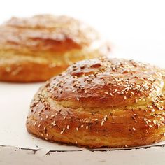 two loaves of bread sitting on top of a table