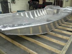 a metal boat being built in a shop